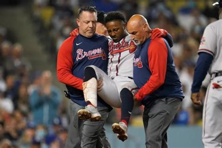 Braves star Albies carried away after fouling ball off knee