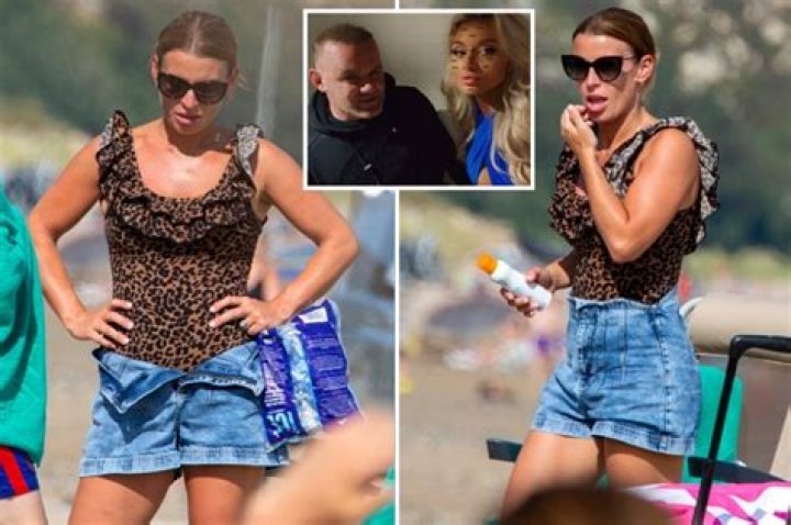 Coleen Rooney spotted on UK beach holiday 24 hours after Wayne filmed in hotel room with semi-naked girls