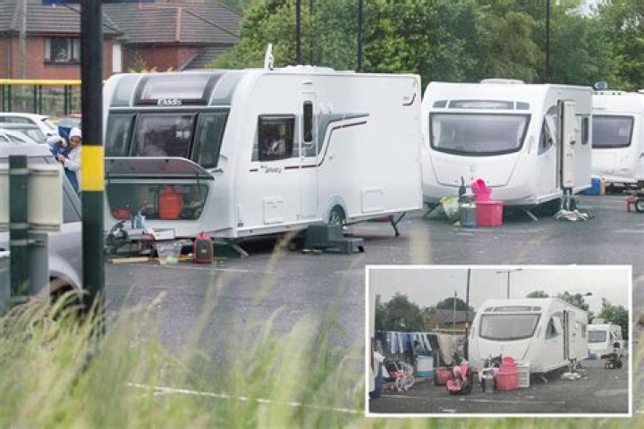 Commuters' fury as travellers take over train station car park with caravans and hang out washing - but police do nothing