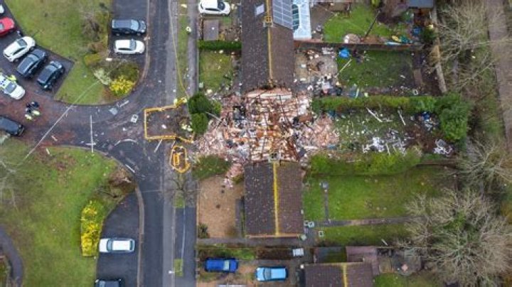 Four injured after suspected gas blast rips through home on residential street as houses evacuated