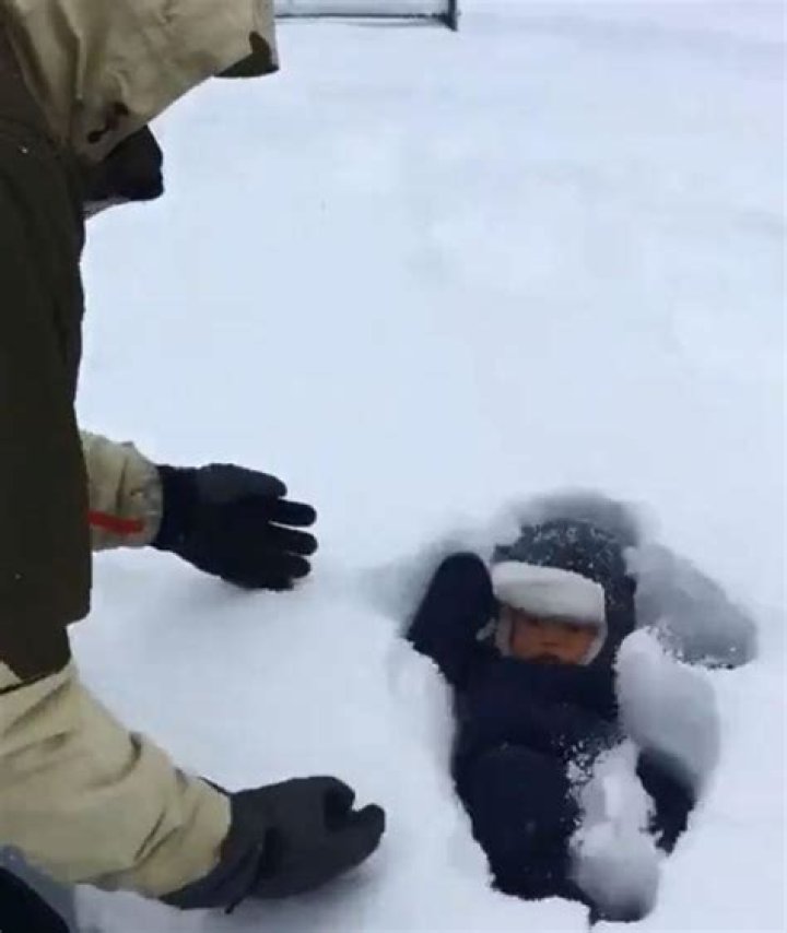 Hilarious moment dad dunks baby son into snow… only for him to completely VANISH beneath drift