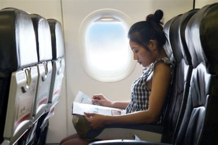 How To Sit Comfortably On A Plane, According To Experts