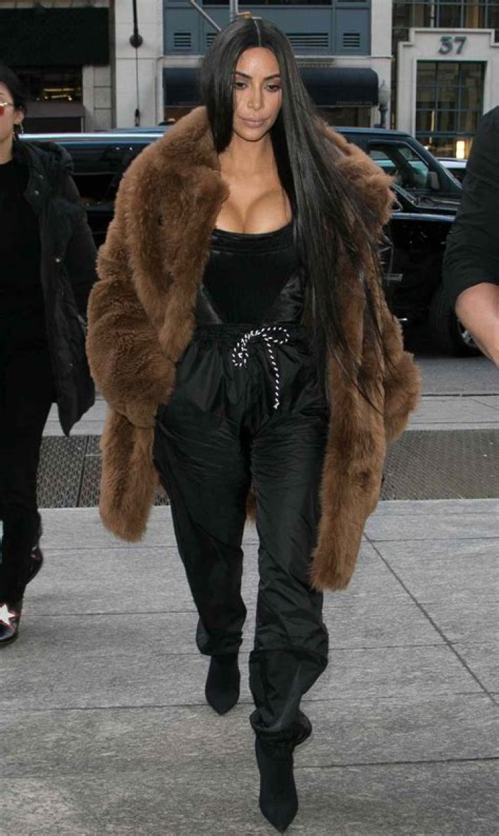Kim Kardashian looks sophisticated in a black suit for the Forbes Women's Summit after being pictured in a tracksuit