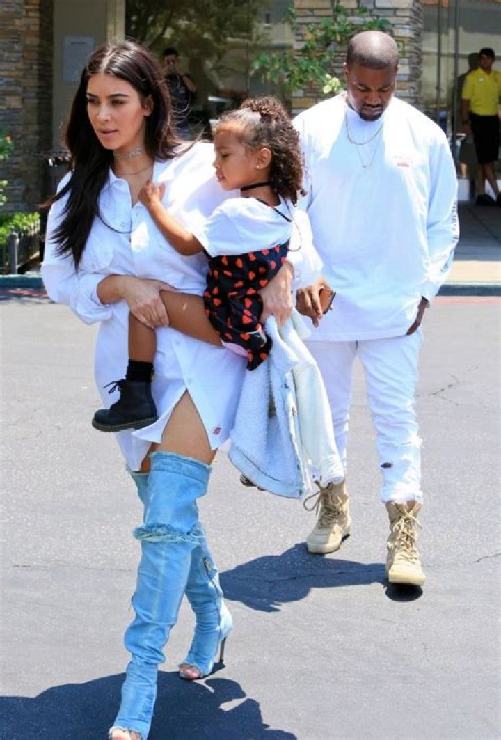 Kim Kardashian wears thigh-high denim boots during a family trip to the cinema – The Sun