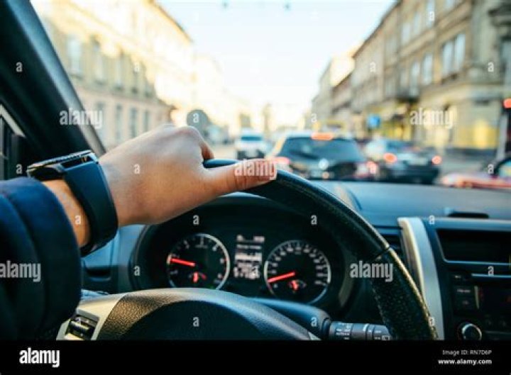 Man films selfie video while sitting on the bonnet of taxi driving around a city after driver 'failed to stop'