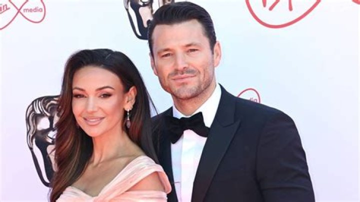 Mark Wright and Michelle Keegan show off their parenting skills as they cuddle new addition to their family