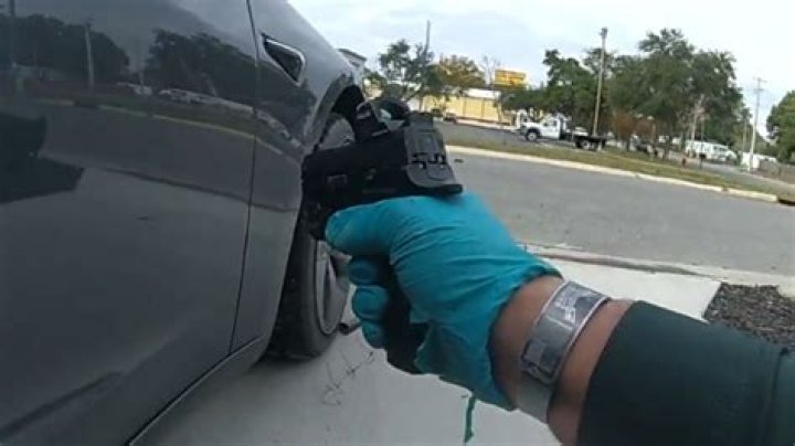 Moment screeching cop opens fire on handcuffed suspect after thinking falling ACORN was gunshot