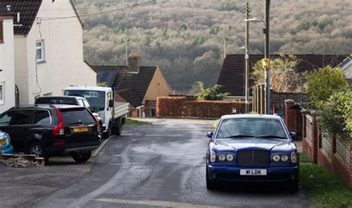 Owner of 'UK's biggest man cave' is BANNED from filming his neighbours on CCTV & clogging up road with his classic cars