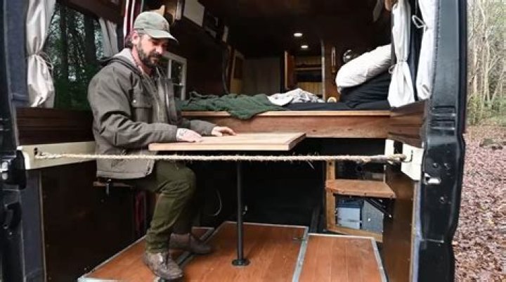 Peugeot van converted into ‘cottage on wheels’ camper with repurposed wood used for ‘rustic’ interior