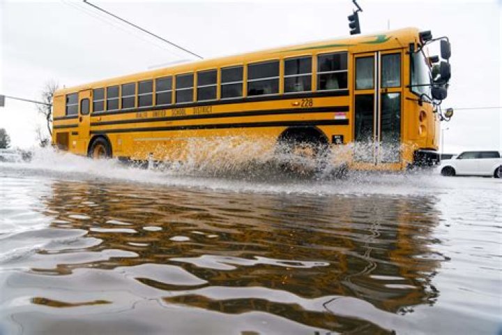 School bus drives through flood