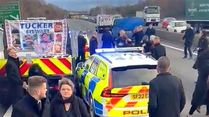 Shocking moment mourners at gypsy funeral are chased by cops as they huddle around COFFIN on back of truck on motorway