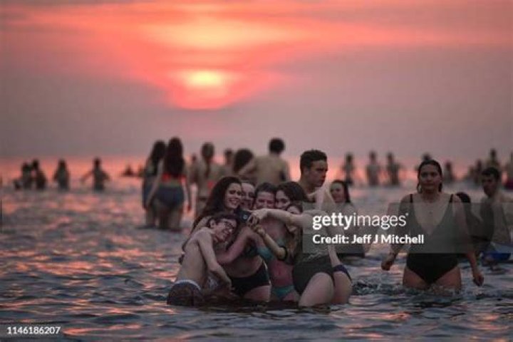 St Andrews University students skinny dip in the sea as May Day celebrations see boozy Oxford students strip off and party till dawn in raucous ritual