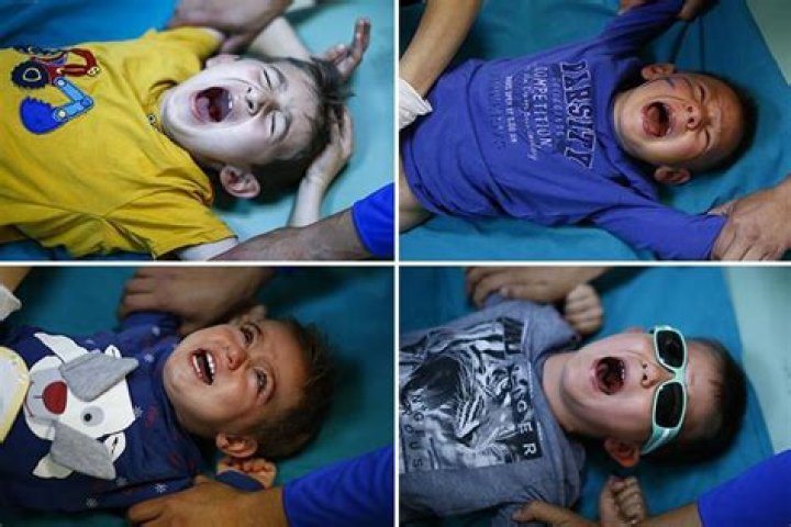 Turkish boys scream as they're put through agonising circumcision ritual in photo series showing their contorted faces